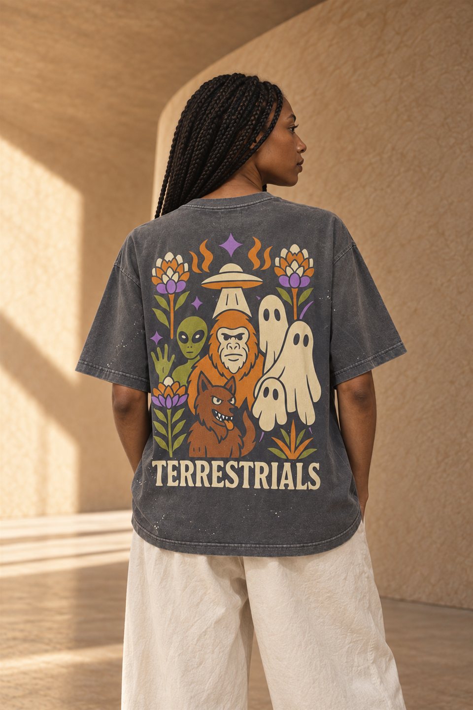 Back detail of a charcoal Terrestrials shirt with colorful illustrated artwork